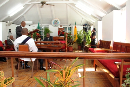 Premier of Nevis and Minister of Finance, Hon. Joseph Parry in the House of Assembly among empty Opposition benches.